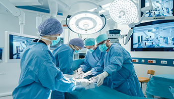 Group of surgeons performing surgery