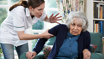 A nurse yelling to a senior woman